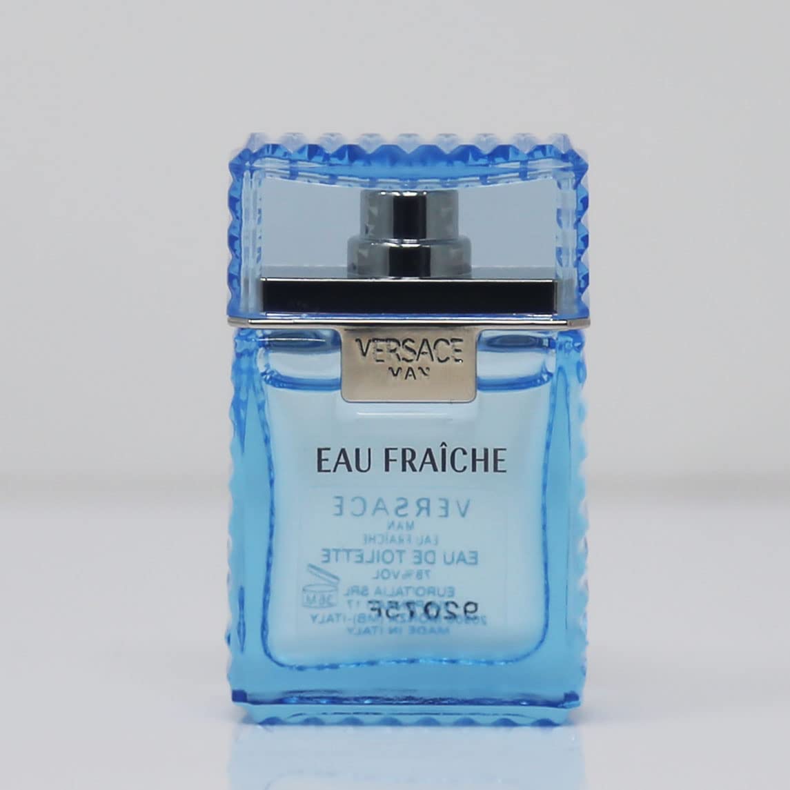 Versace Man Eau Fraiche mini spray bottle in use for casual evening.