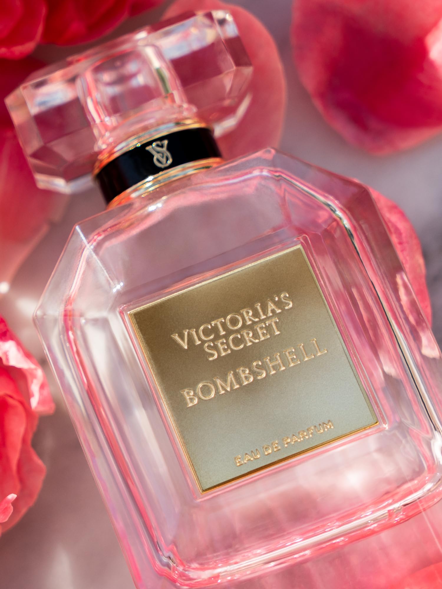 Victoria's Secret Bombshell spray gesture, easy application for lasting fragrance.