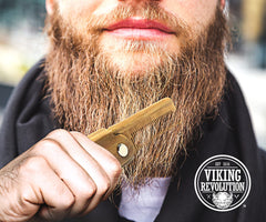 Viking Revolution green-sandalwood folding-beard-comb close-up shows smooth wood texture.