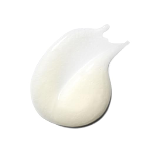 Close-up of creamy foam from VIRTUE Smooth Shampoo forming a rich lather.