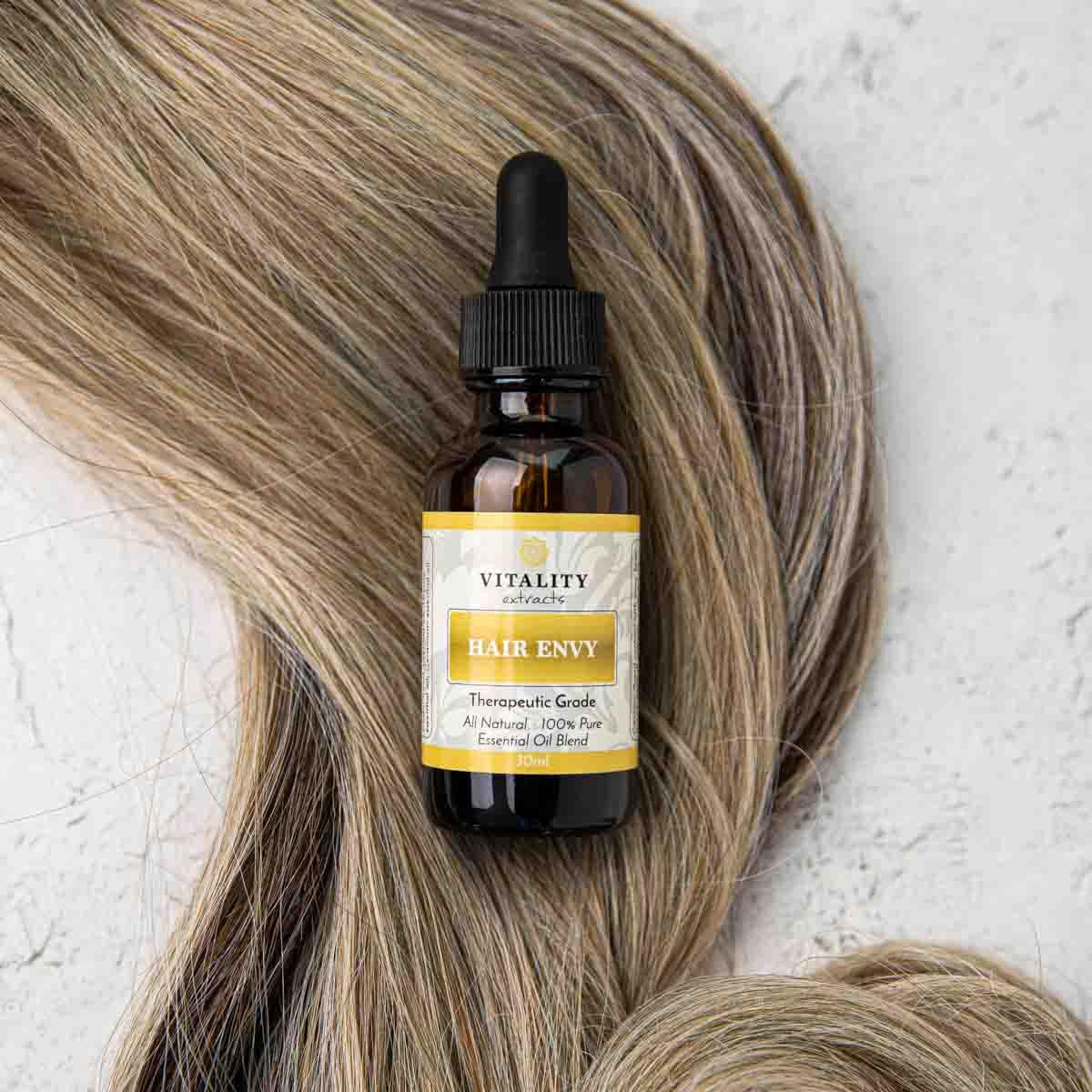 Vitality Hair Envy scalp-massage scene shows easy application.