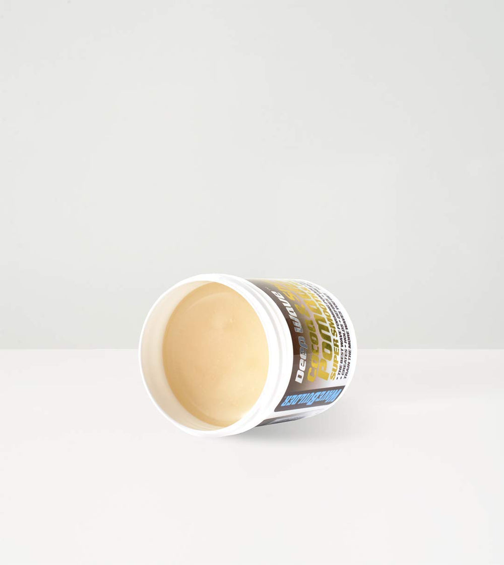 Applying WaveBuilder Cocoa & Shea Pomade with hands for easy, even distribution.