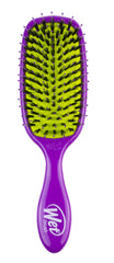 Wet Brush Shine Enhancer bottle in hand highlights its purple design and easy grip.