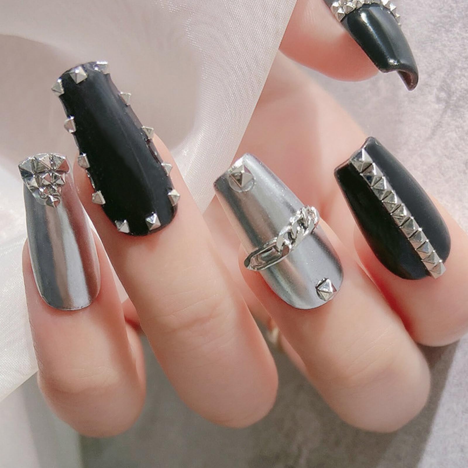 WOKOTO silver pyramid nail-art close-up on a decorated nail
