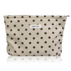 Wudygirl makeup bag in beige polka dot with corduroy texture for travel organization.