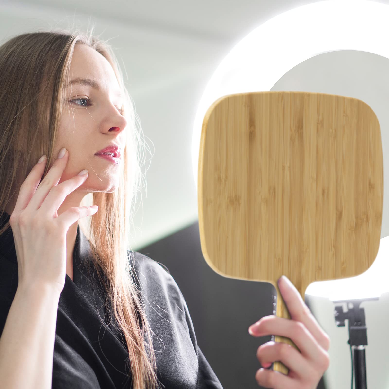 YEAKE bamboo mirror can be hung or handheld for versatile use.