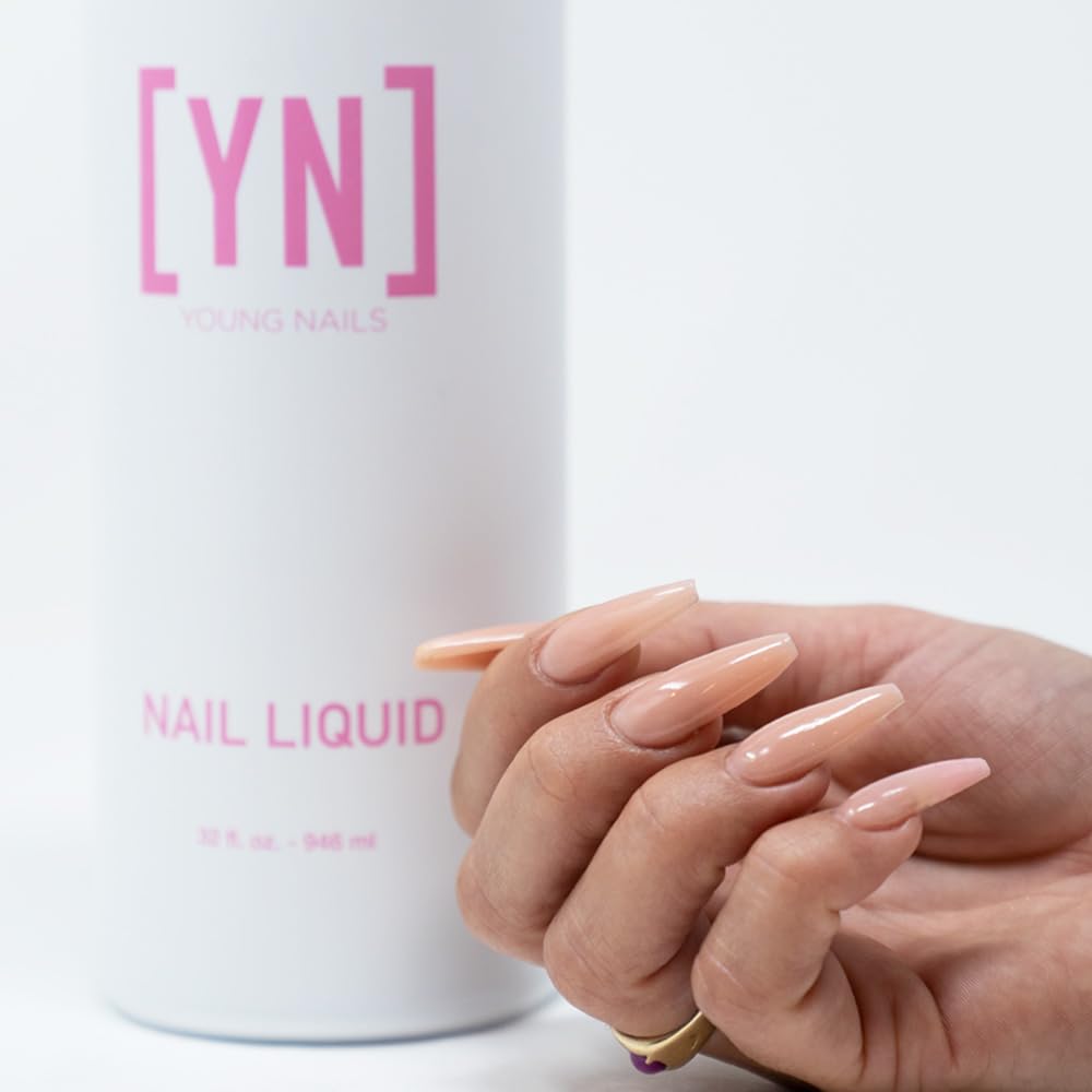 Acrylic powder base application with Young Nails monomer for strong foundation.
