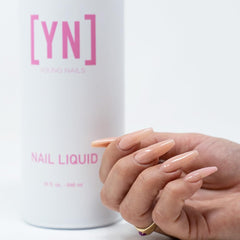 Acrylic powder base application with Young Nails monomer for strong foundation.