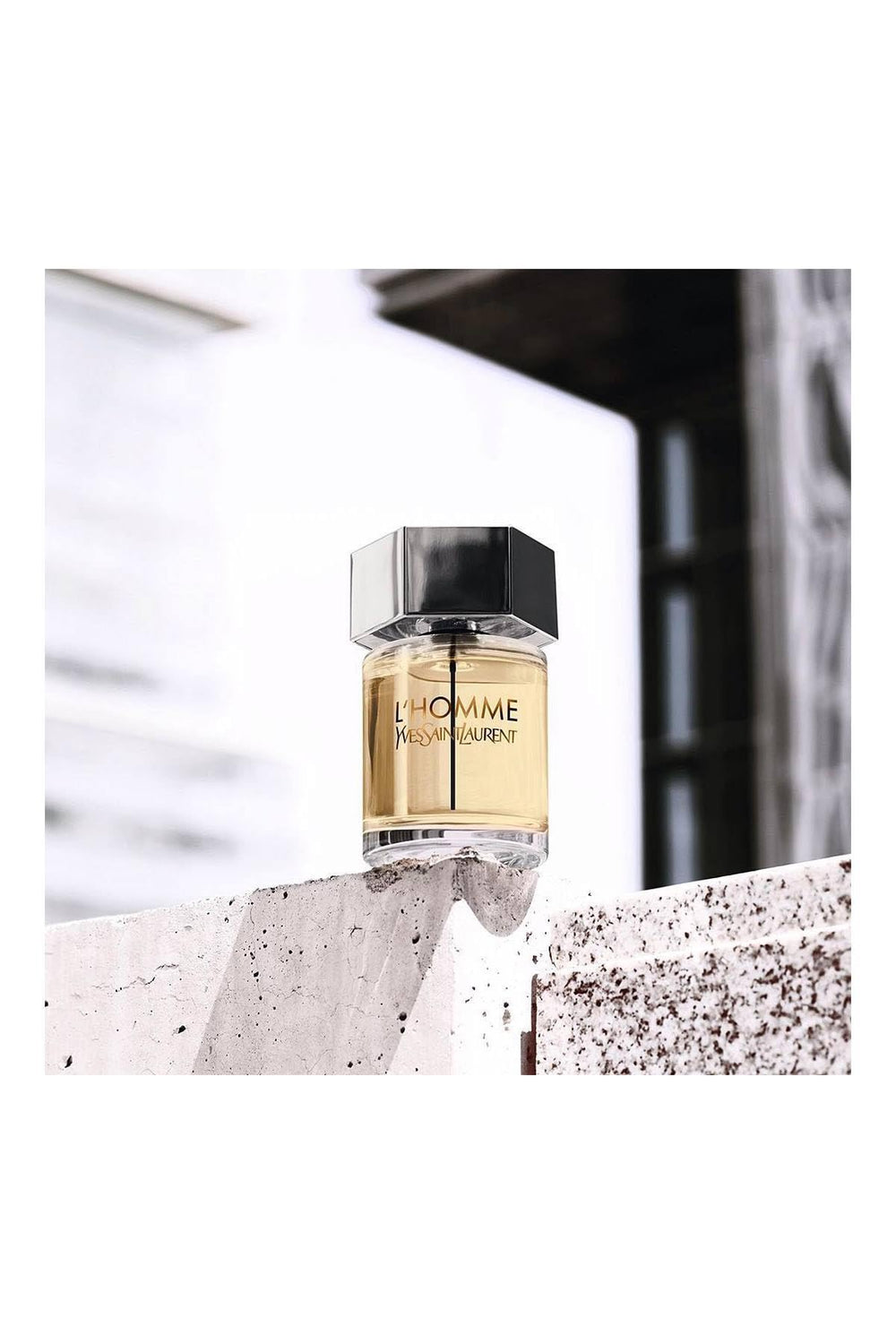 YSL L'Homme bottle angled shot, premium masculine aesthetic.
