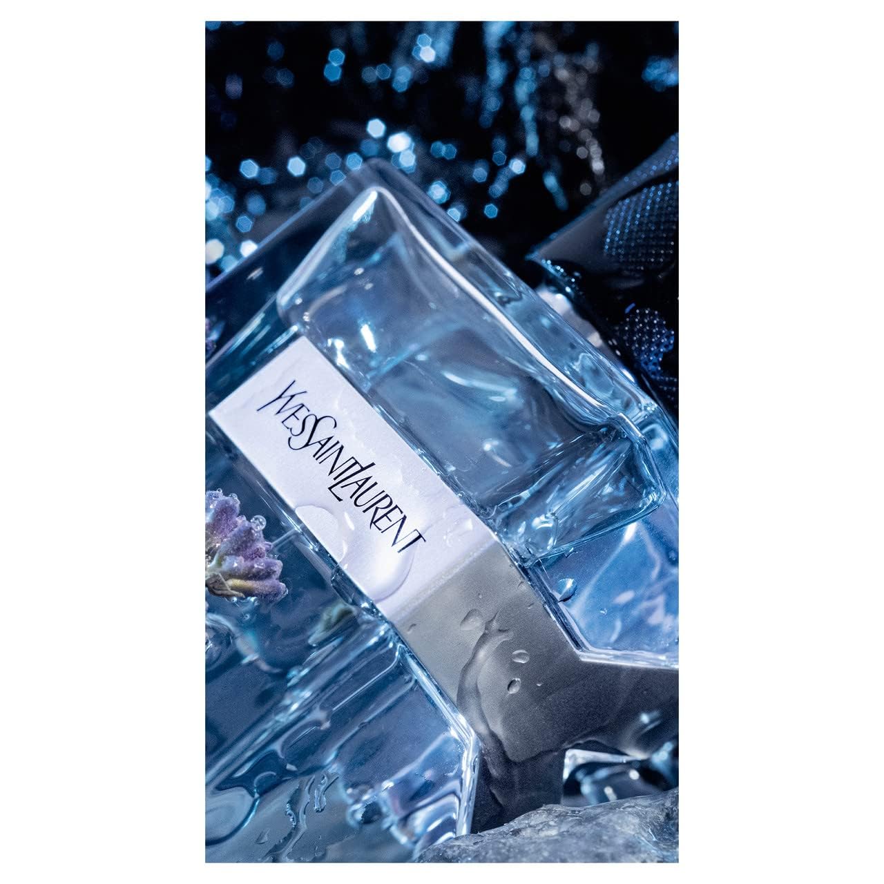 Yves Saint Laurent Y fragrance note close-up, bergamot and sage hinting at sharp freshness.